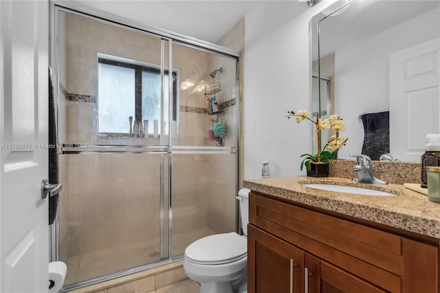 bathroom featuring an enclosed shower, vanity, toilet, and tile patterned floors