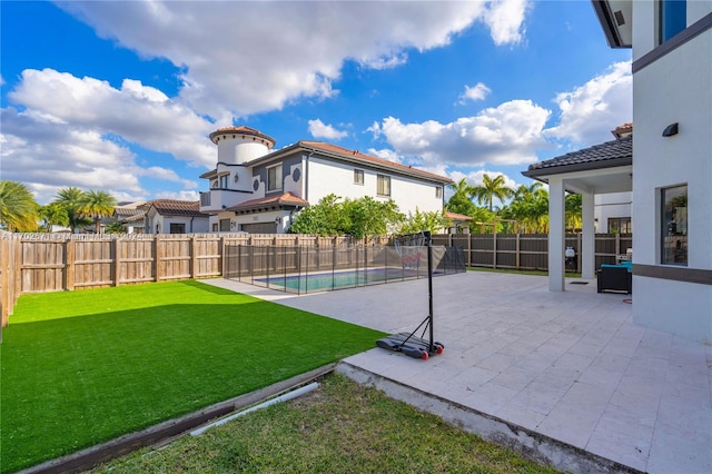 view of pool featuring a yard and a patio