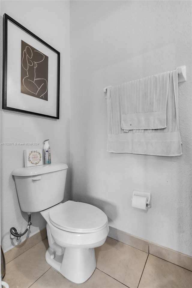 bathroom with tile patterned flooring and toilet