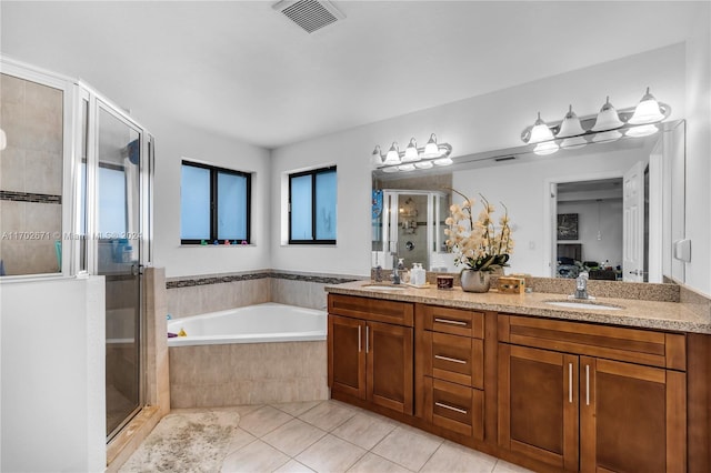 bathroom with plus walk in shower, vanity, and tile patterned floors