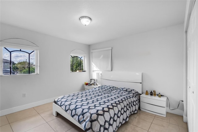 bedroom with a closet and light tile patterned floors