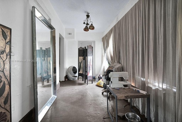 miscellaneous room featuring concrete floors and a textured ceiling