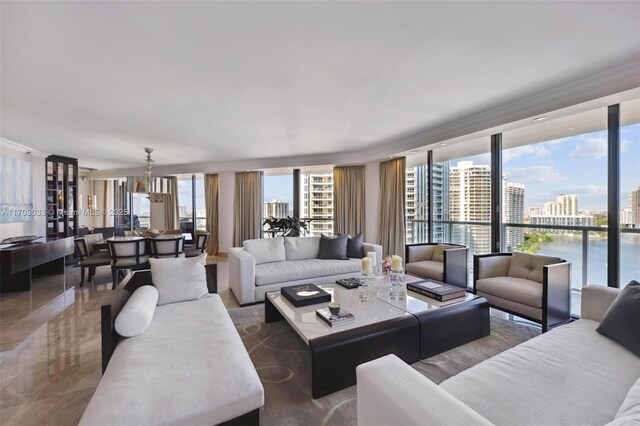 living room featuring floor to ceiling windows and a water view