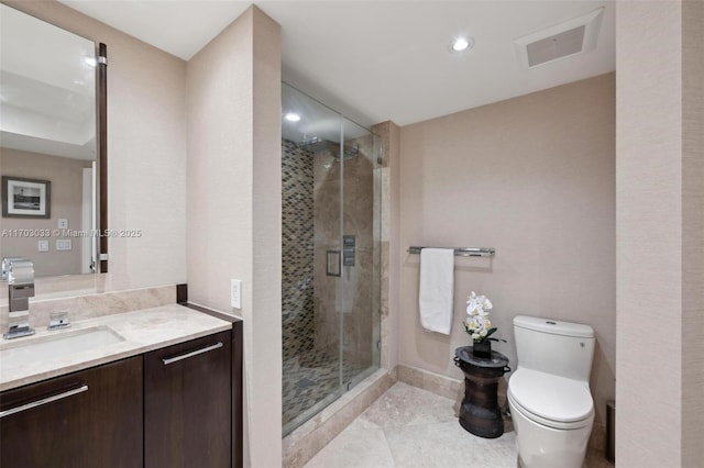 bathroom featuring an enclosed shower, vanity, and toilet