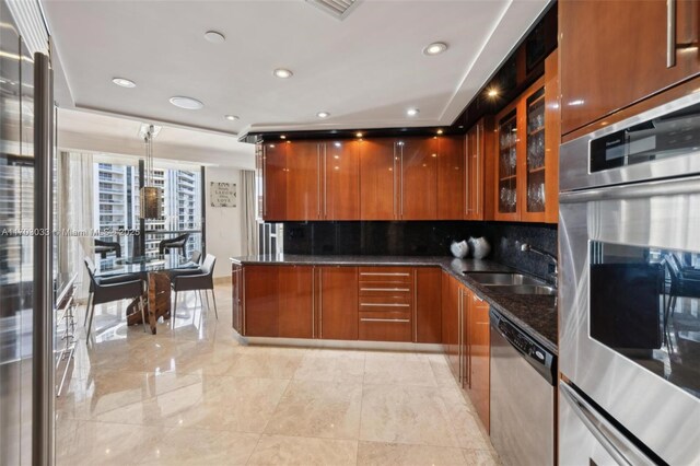 kitchen featuring decorative light fixtures, dark stone countertops, sink, and stainless steel appliances