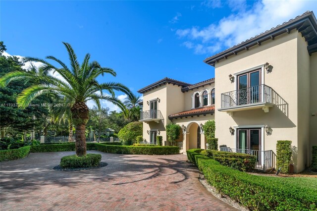 5935 Moss Ranch Rd, Pinecrest, FL 33156 - view of front of home featuring a balcony, french doors, and stucco siding
