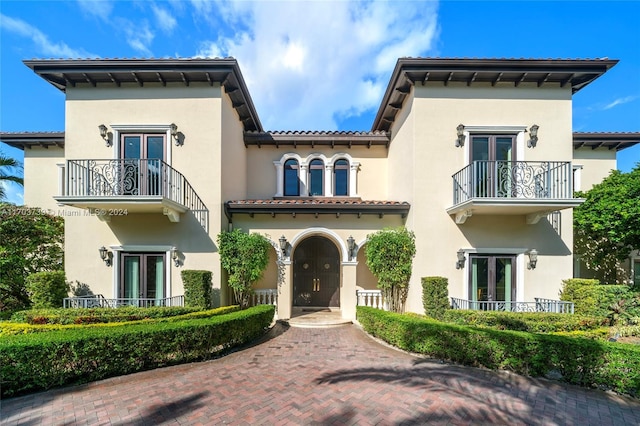 5935 Moss Ranch Rd, Pinecrest, FL 33156 - view of front of home featuring french doors, a balcony, and stucco siding