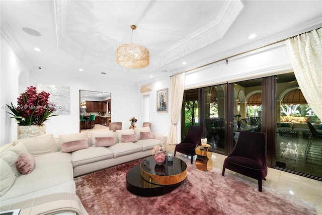 living room with a raised ceiling, a healthy amount of sunlight, and ornamental molding