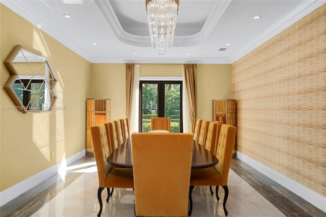 dining area featuring a chandelier, french doors, crown molding, and a tray ceiling