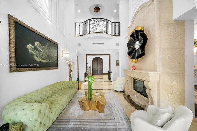 5935 Moss Ranch Rd, Pinecrest, FL 33156 - tiled living room with a high end fireplace and a towering ceiling