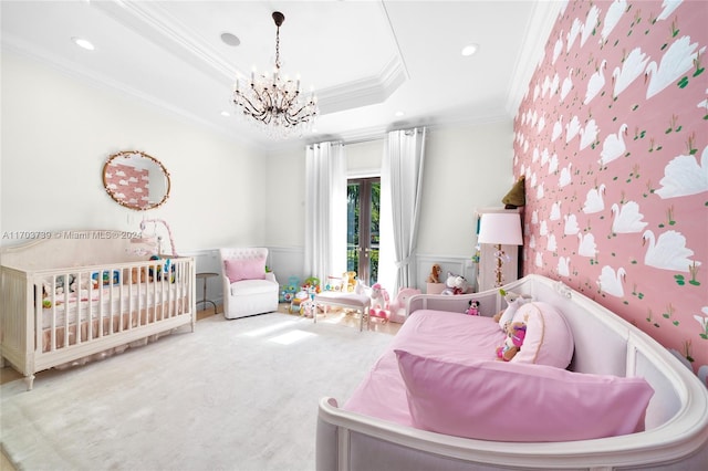 bedroom with carpet, ornamental molding, a tray ceiling, and an inviting chandelier