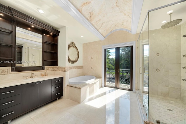 bathroom with french doors, crown molding, independent shower and bath, and tile walls