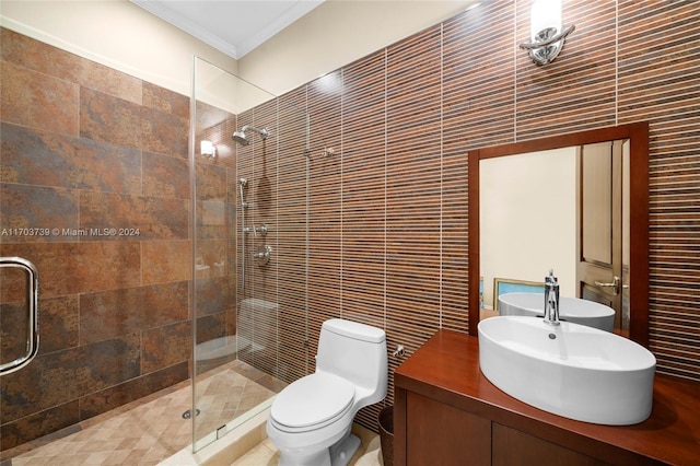 bathroom featuring sink, crown molding, toilet, a shower with shower door, and tile walls