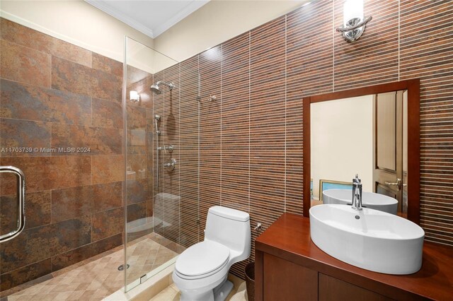 5935 Moss Ranch Rd, Pinecrest, FL 33156 - bathroom featuring tile walls, ornamental molding, a shower stall, vanity, and toilet
