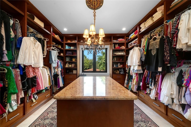 walk in closet featuring a chandelier