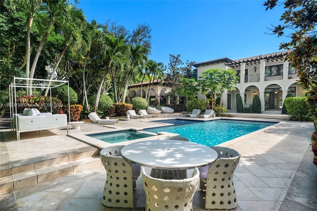 view of pool featuring an in ground hot tub and a patio