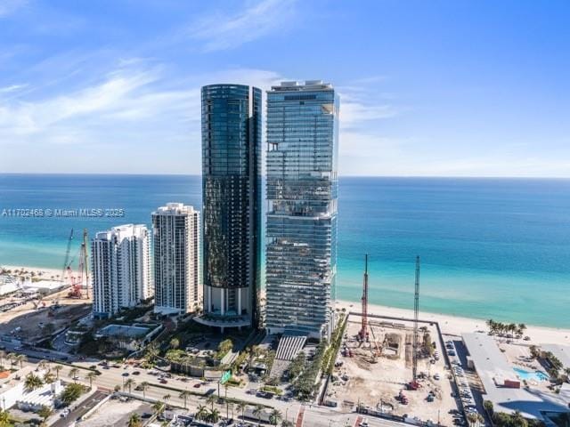 aerial view with a view of the beach, a water view, and a city view