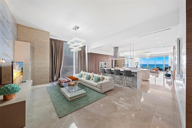 living room with a water view and an inviting chandelier