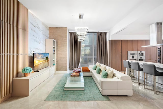 living room with wood walls and a chandelier