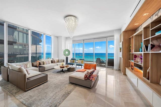 living room with a notable chandelier, a healthy amount of sunlight, and a water view