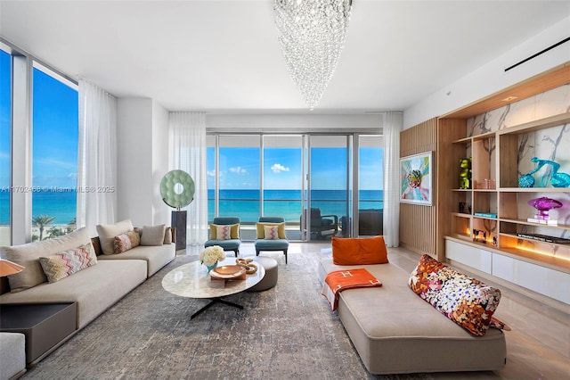 living room featuring a water view and an inviting chandelier