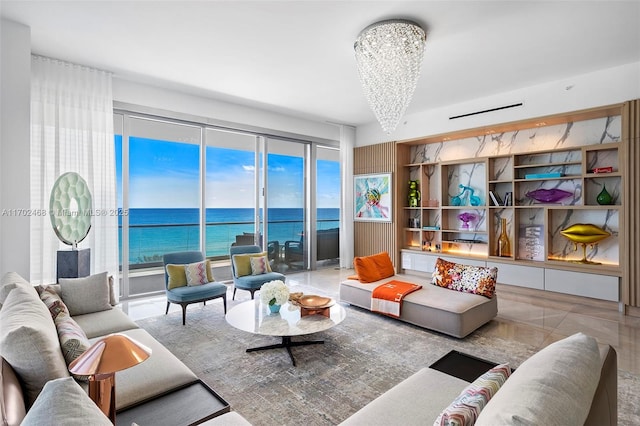 living area featuring a water view and an inviting chandelier