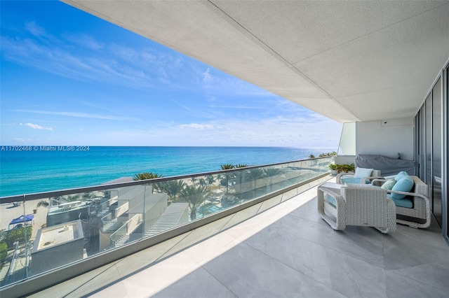 balcony with a beach view, a water view, and an outdoor hangout area