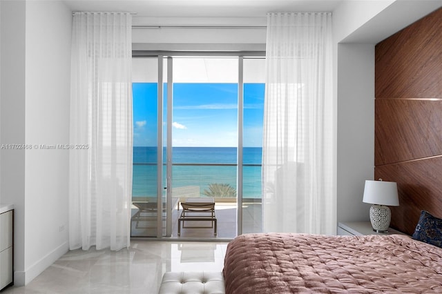 bedroom with access to outside and a water view