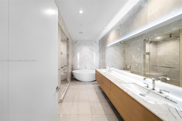 bathroom featuring tile patterned flooring, vanity, tile walls, and shower with separate bathtub