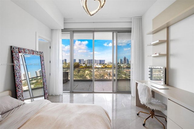 bedroom featuring access to exterior, built in study area, and a city view