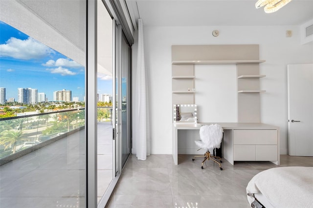 bedroom featuring built in desk and a city view