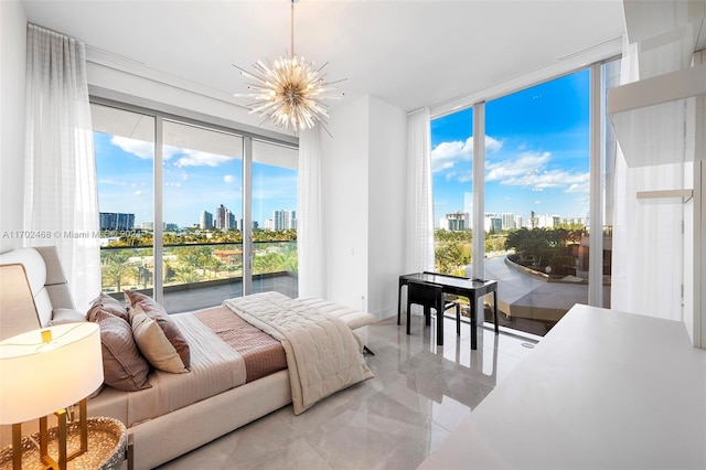 bedroom featuring expansive windows, access to exterior, and an inviting chandelier