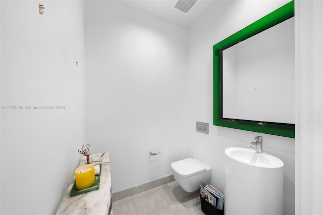 bathroom with tile patterned floors, toilet, and sink