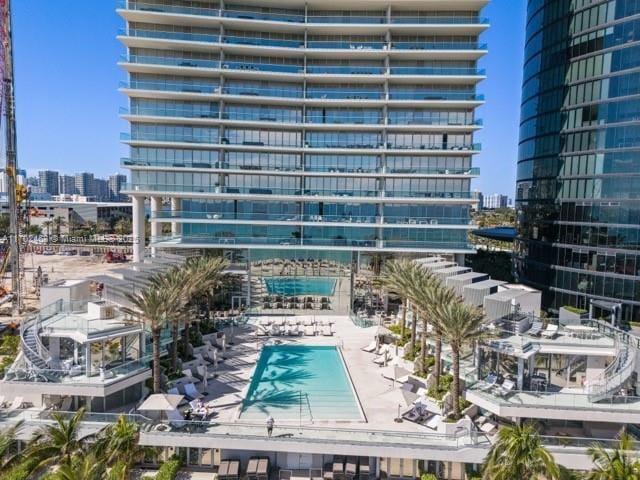 view of building exterior with a city view and a community pool