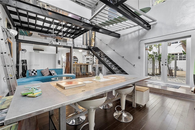 kitchen featuring washer and dryer, a high ceiling, and dark hardwood / wood-style flooring