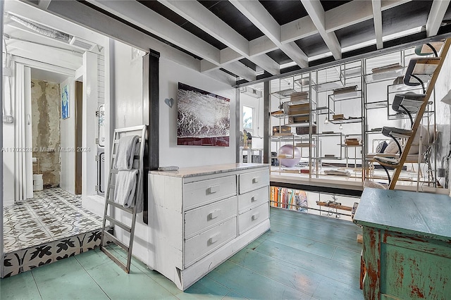 walk in closet featuring beamed ceiling and coffered ceiling