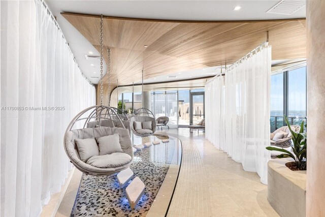 tiled living room with wood ceiling and a wealth of natural light