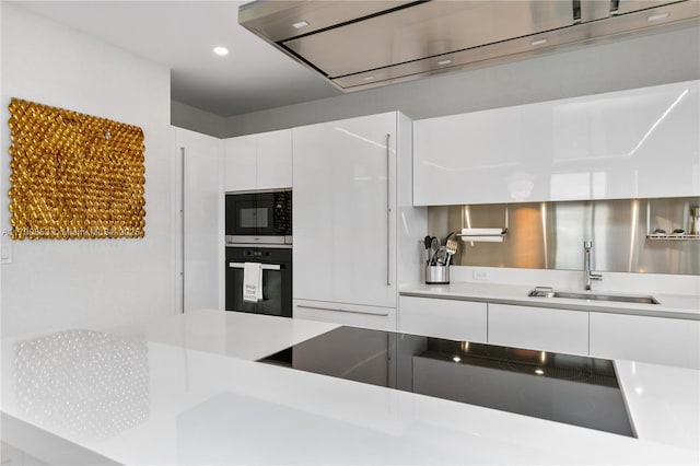 kitchen featuring white cabinets, wall chimney range hood, sink, and black appliances