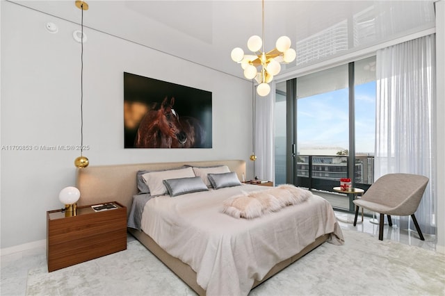 bedroom featuring access to outside and a notable chandelier