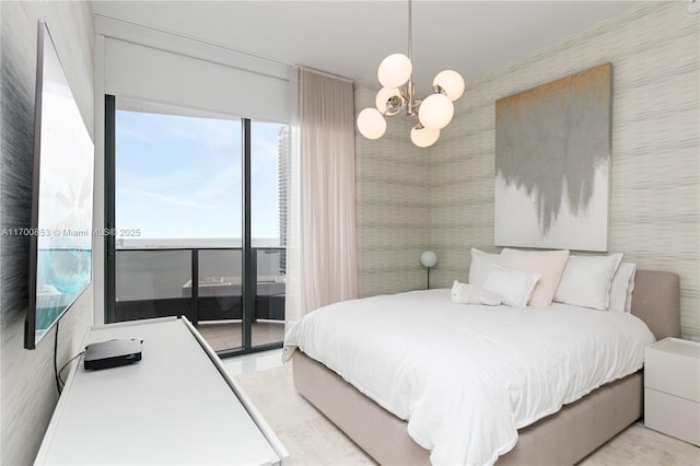 bedroom featuring access to outside and a notable chandelier