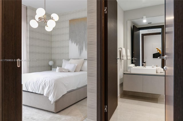 tiled bedroom featuring ensuite bath and sink