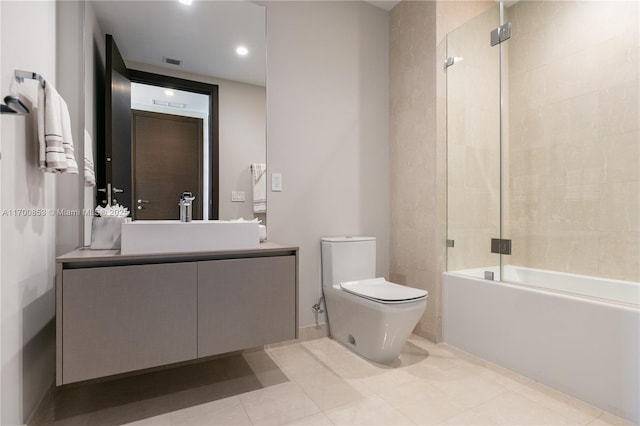 full bathroom featuring toilet, vanity, and shower / bath combination with glass door