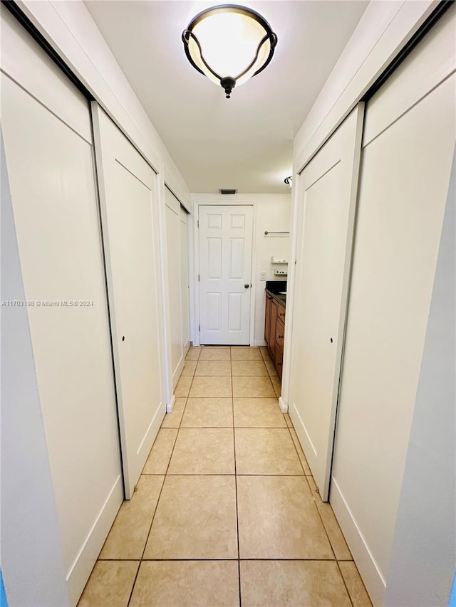 corridor with light tile patterned floors