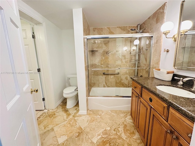 full bathroom featuring vanity, toilet, and enclosed tub / shower combo