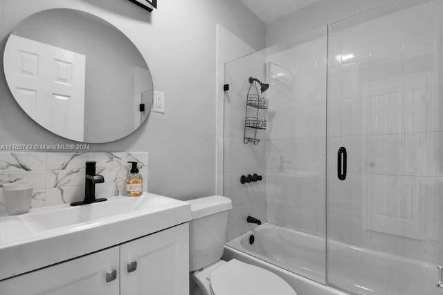 full bathroom with shower / bath combination with glass door, tasteful backsplash, vanity, and toilet