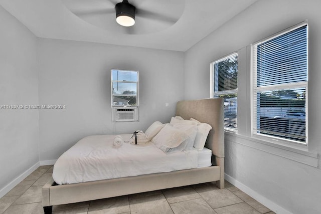 tiled bedroom with ceiling fan and cooling unit