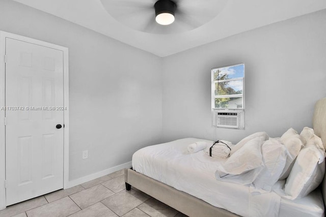 bedroom featuring cooling unit, ceiling fan, and light tile patterned floors