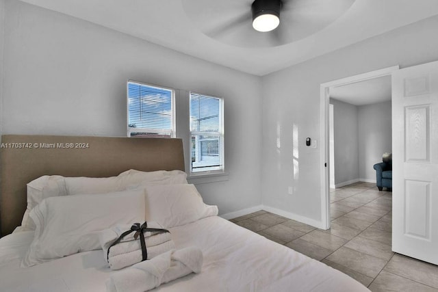 tiled bedroom with ceiling fan