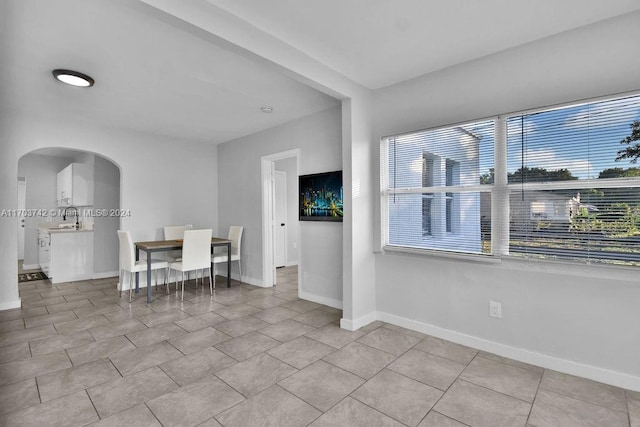 interior space with light tile patterned floors and sink