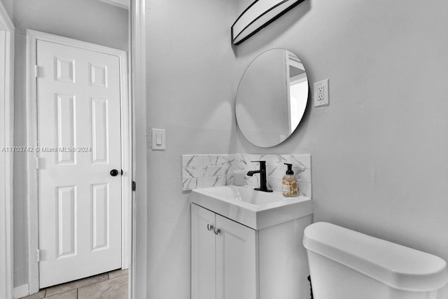 bathroom featuring tile patterned flooring, vanity, and toilet